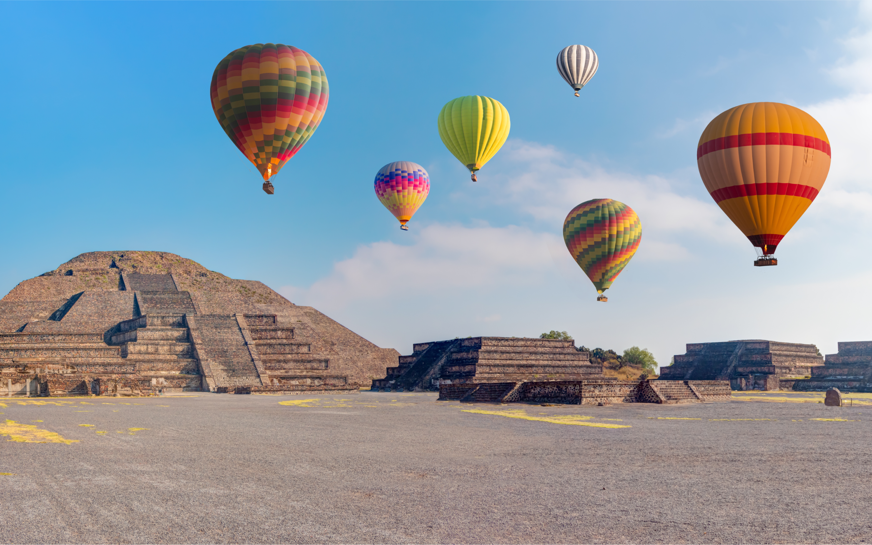 Photo of balloons flying over buildings in Mexico
